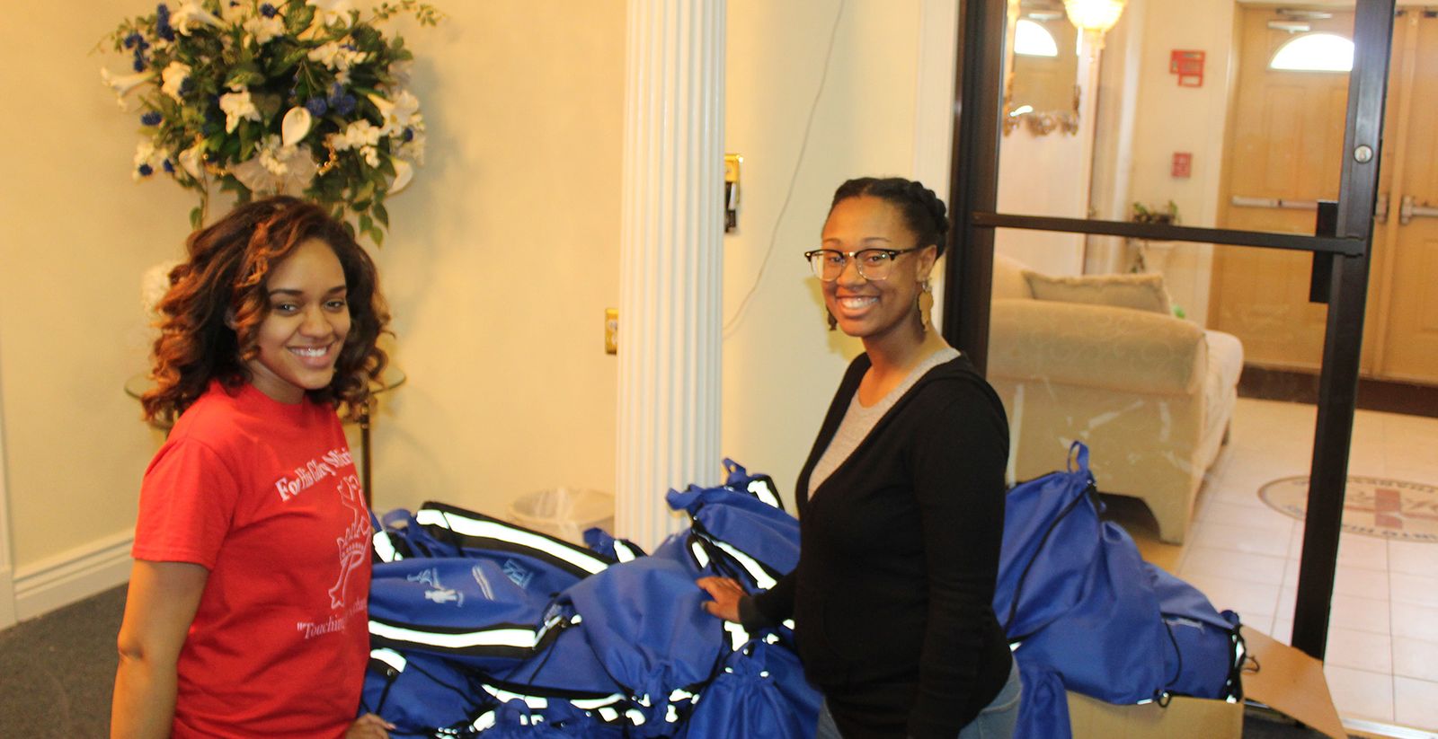 Volunteers with care bags prepared for the community