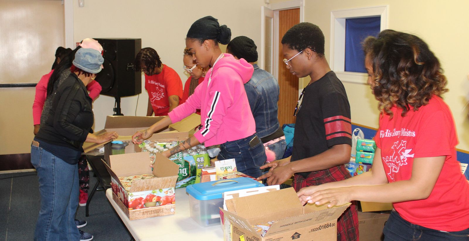 Volunteers packing boxes of supplies for the homeless ministry